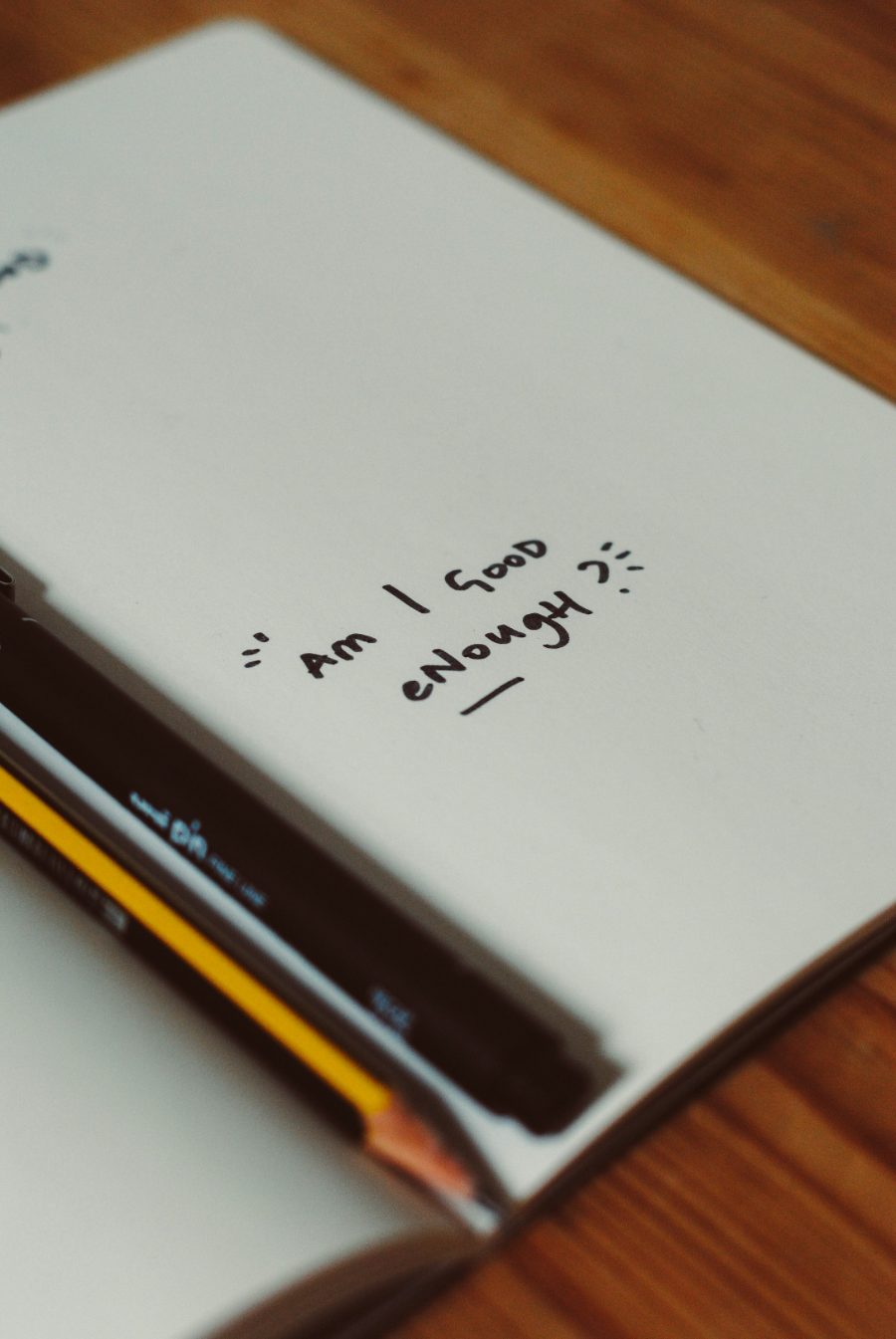 Notebook page with the handwritten question: am I good enough?