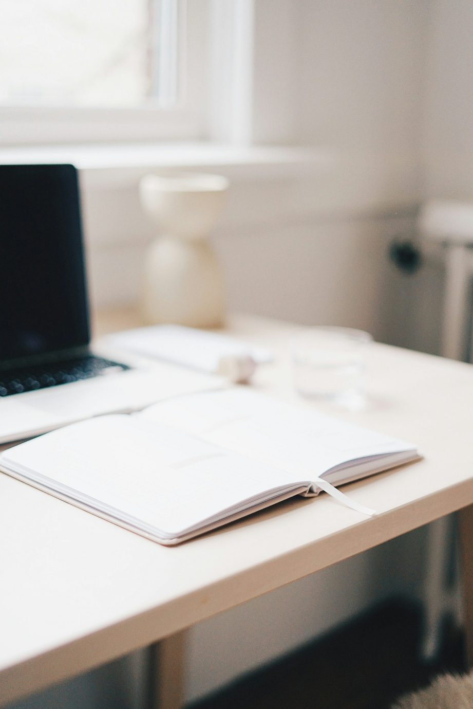 Open notebook on a bright desk
